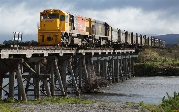 yellow locomotive, wooden bridge, cars