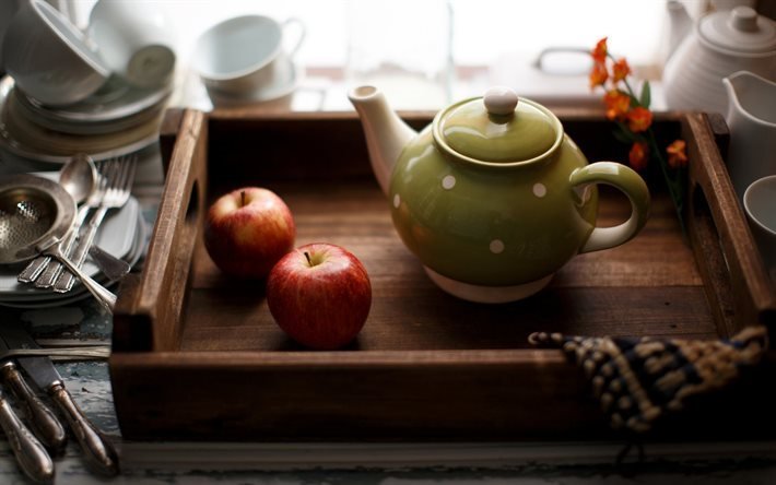 green teapot, wooden tray, apples