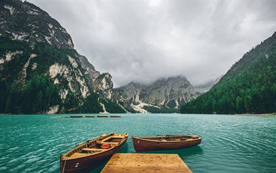 Mountain lake, dock, wooden boats, mountain landscape, fog