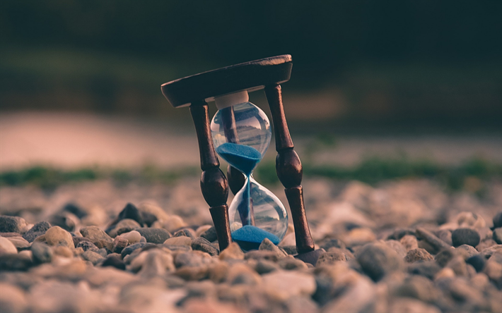 wooden hourglass, time concepts, beach, blue sand, old clock
