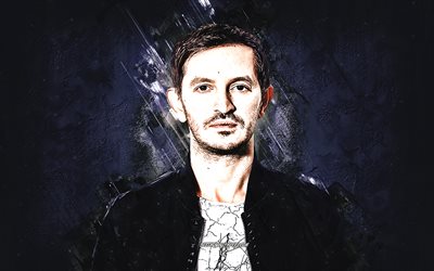 Burak Yeter, Turkish DJ, portrait, purple stone background, EDM