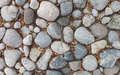 pierres dans le sol, texture de galets, grandes pierres, texture de pierre, fond avec des pierres