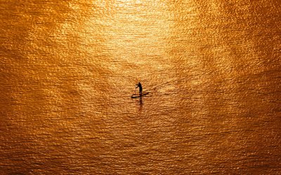 loneliness concepts, sea, evening, sunset, riding on a board, loneliness