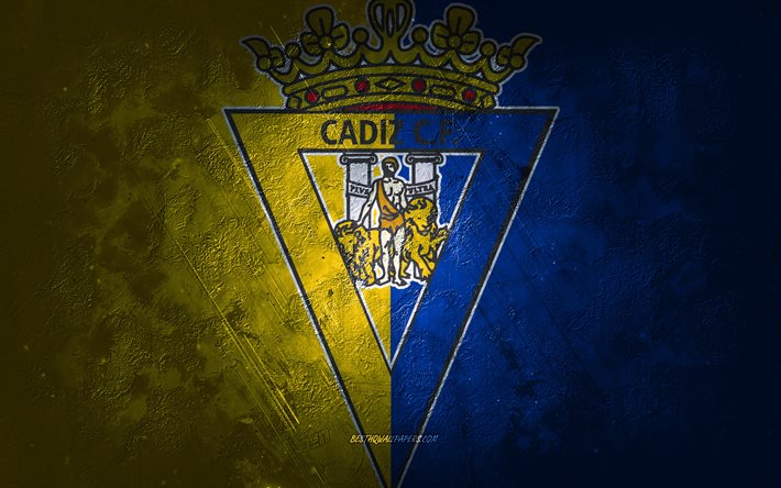 Cadiz CF, Spanish football club, blue yellow stone background, Cadiz CF logo, grunge art, La Liga, football, Spain, Cadiz CF emblem