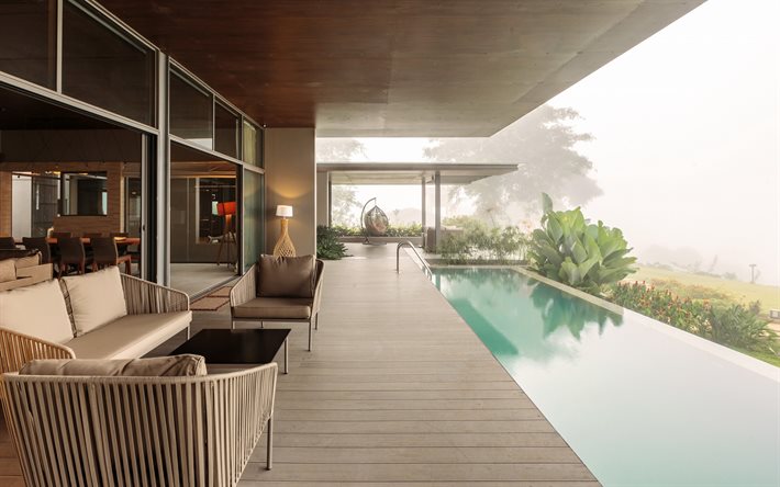 moderna casa di campagna, piscina sulla terrazza, terrazza con assi di legno, sedia in metallo sospesa, palla per sedia sospesa, design elegante della piscina