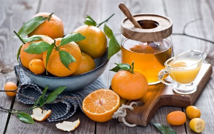 tangerines, board, jar of honey