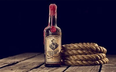 wooden table, a bottle of rum, rope