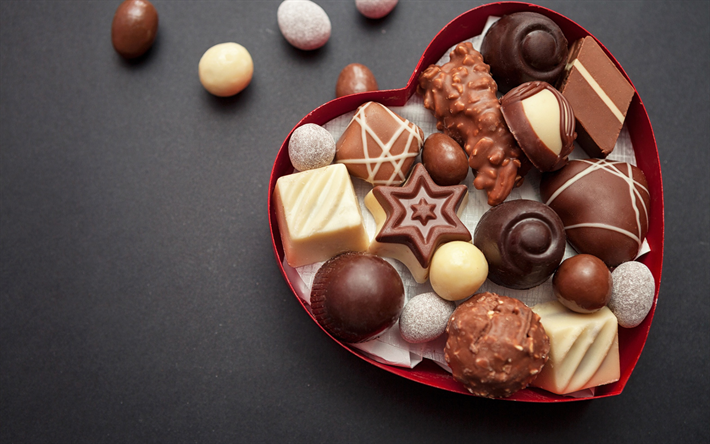 chocolates, sweets, various candies, white chocolate, gray background