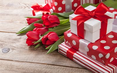 Il Giorno di san valentino, regalo, rosso, nastri di seta, tulipani rossi, fiocco rosso