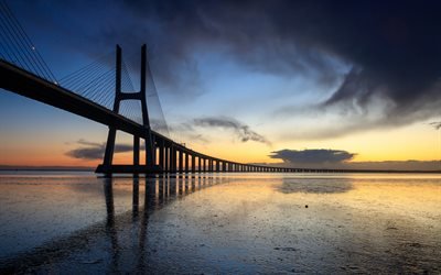 Vasco da Gama bridge, cable-stayed bridge, river, Tejo, Lisbon, Portugal, evening, sunset, modern buildings, modern bridges