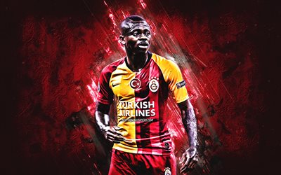 Jean Michael Seri, Galatasaray, Ivorian footballer, midfielder, portrait, red stone background, football