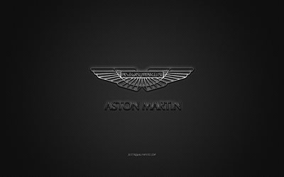 Aston Martin-logotyp, silvergul logotyp, gr&#229; kolfiberbakgrund, Aston Martin metallemblem, Aston Martin, bilm&#228;rken, kreativ konst