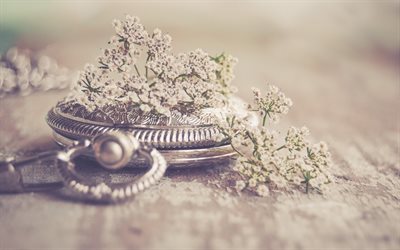 old pocket watch, bokeh, time concepts, retro style, silvery clock, wild flowers