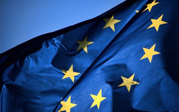 EU flag, blue fabric flag, Flag of European Union, flag on sky background, Europe