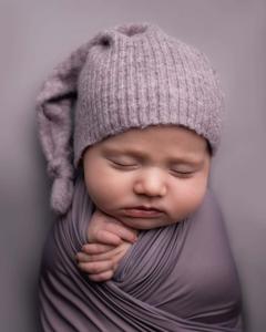 A baby boy in his mother’s arms enjoying the tender moment. baby boy wallpaper
