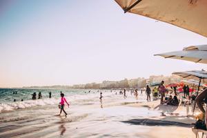 a beach with umbrellas beach wallpaper