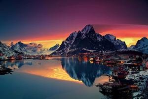 a beautiful sunset over a lake and mountains 1440p wallpaper