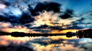 a beautiful sunset over a lake with clouds 1080p wallpaper