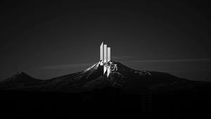 a black and white photo of a mountain with a mountain logo dark wallpaper