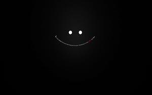 a black background with a smiling face dark wallpaper