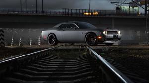 a black car is driving down the tracks at night dodge challenger 4k wallpaper
