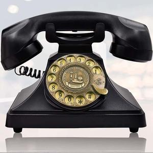 a black telephone with a gold dial phone wallpaper