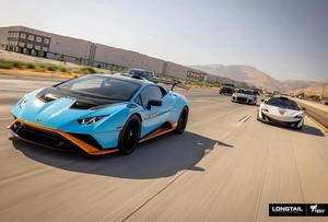 a blue and orange sports car driving down the road lamborghini wallpaper