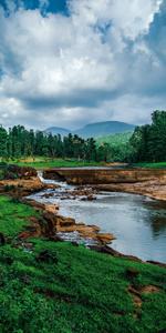 A calming river winds through the lush green landscape. landscape wallpaper