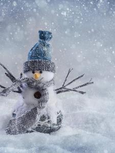 A Charming Winter Scene with a Little Snowman on an iPhone winter iphone wallpaper