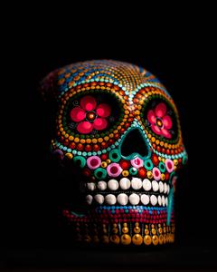 A colorful skull appears on a black screen black screen wallpaper