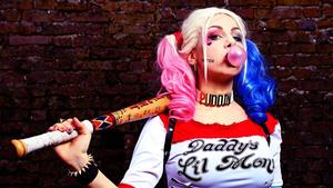 A cosplayer dressed as the iconic DC Comic character, Harley Quinn. harley quinn wallpaper