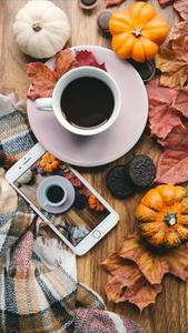 a cup of coffee and a cup of pumpkins on a wooden table fall iphone wallpaper