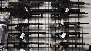 a display of guns on display in a store gun wallpaper