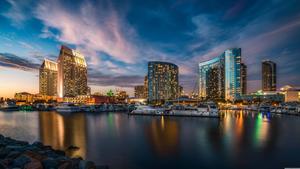 A gorgeous San Diego skyline illuminated by the sunset 8k wallpaper