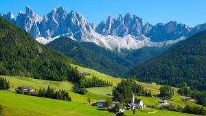 a green valley with mountains in the background landscape wallpaper