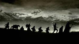 a group of people are silhouetted in the dark lord of the rings wallpaper