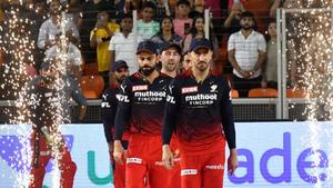 a group of players standing on a field with sparklers rcb wallpaper