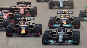 a group of racing cars are racing down a track f1 wallpaper