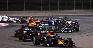 a group of racing cars are racing down a track f1 wallpaper