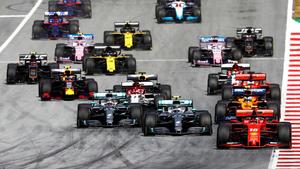 a group of racing cars are racing down a track f1 wallpaper
