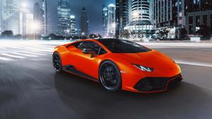 a lamborghini huracan is driving down the street at night lamborghini wallpaper