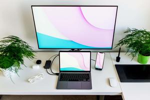 A laptop resting on a soft mattress. laptop wallpaper