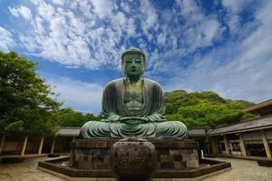 a large statue of a buddha in a courtyard buddha wallpaper