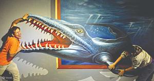 a man and woman standing next to a painting of a shark Wallpaper
