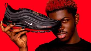 a man holding up a black nike air max 97 nike wallpaper