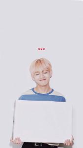 a man holding up a white board bts v wallpaper
