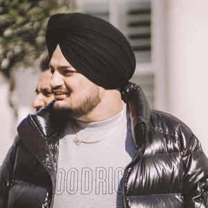 a man in a black jacket and turban Wallpaper