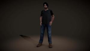 a man in a black shirt and jeans standing in front of a dark background Wallpaper