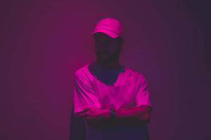 a man in a hat and a cap standing in front of a purple wall instagram profile wallpaper