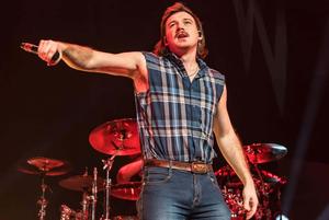 a man in a plaid shirt is holding a microphone morgan wallen wallpaper